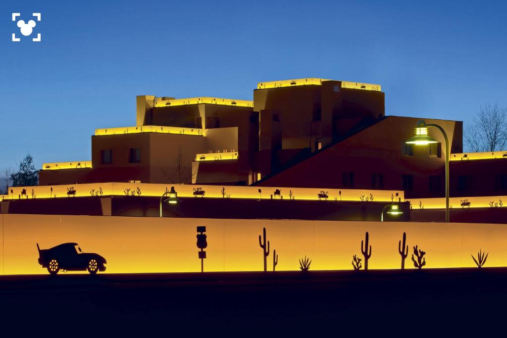 a car is parked in front of a building at Disney Hotel Santa Fe in Coupvray