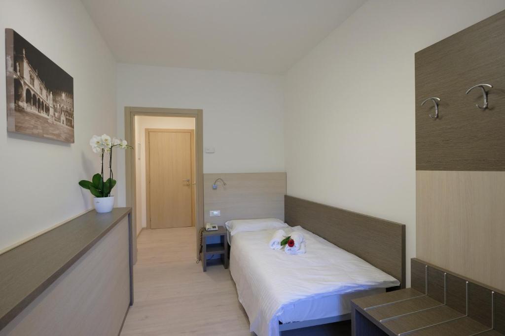 Postel nebo postele na pokoji v ubytování Hotel Gelmini