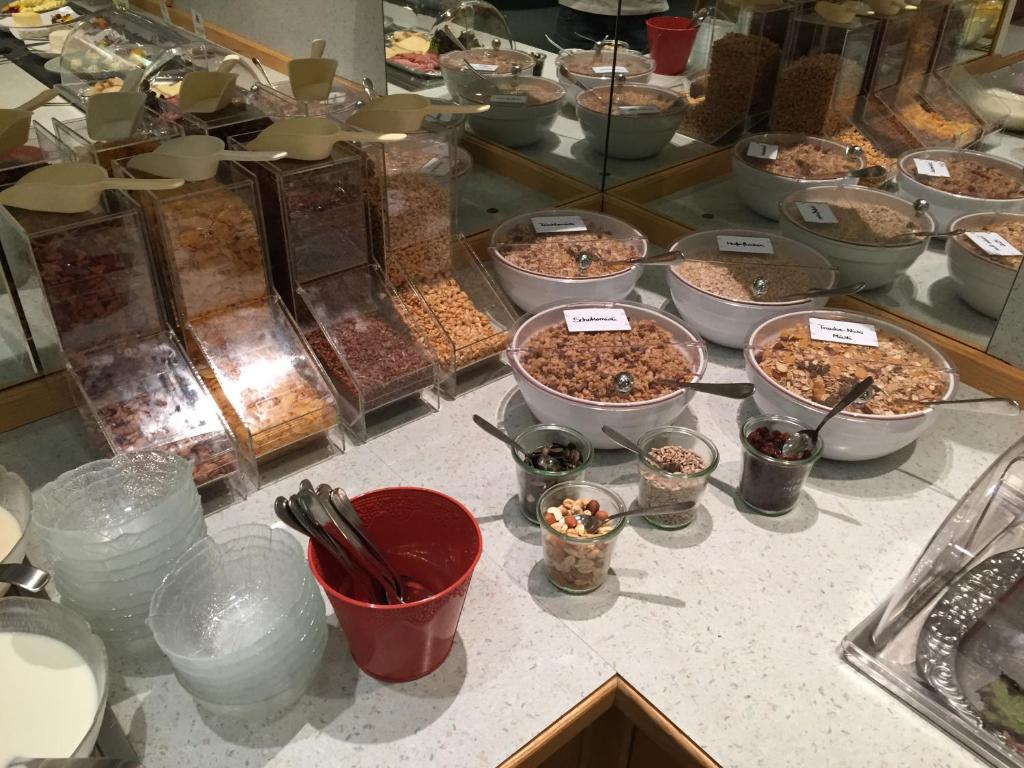 a counter with many bowls of food on a table at Hotel Styrolerhof in Steeg