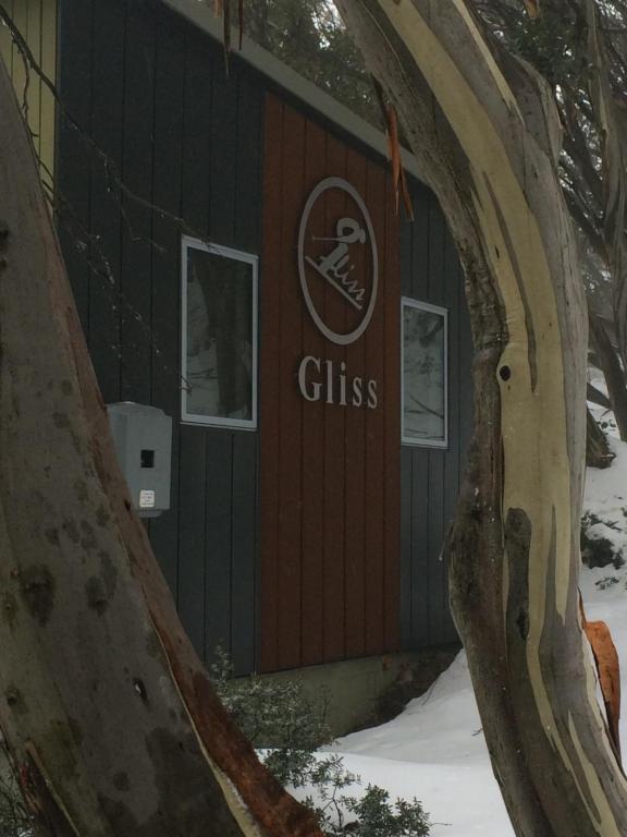 a cabin with a sign on the door of it at Gliss Ski Club in Mount Buller