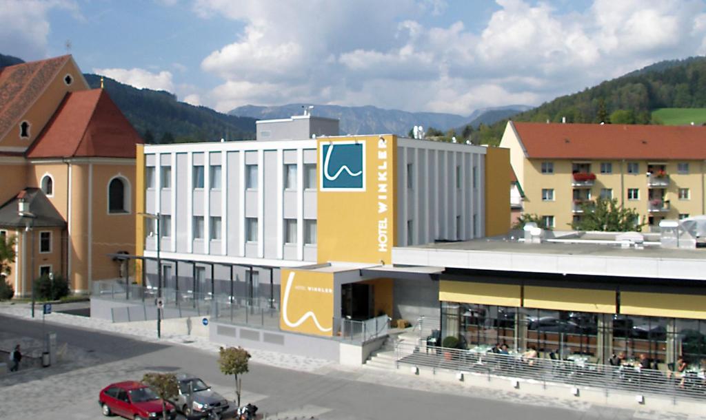 a building with a sign on the side of it at Hotel Restaurant Winkler in Mürzzuschlag