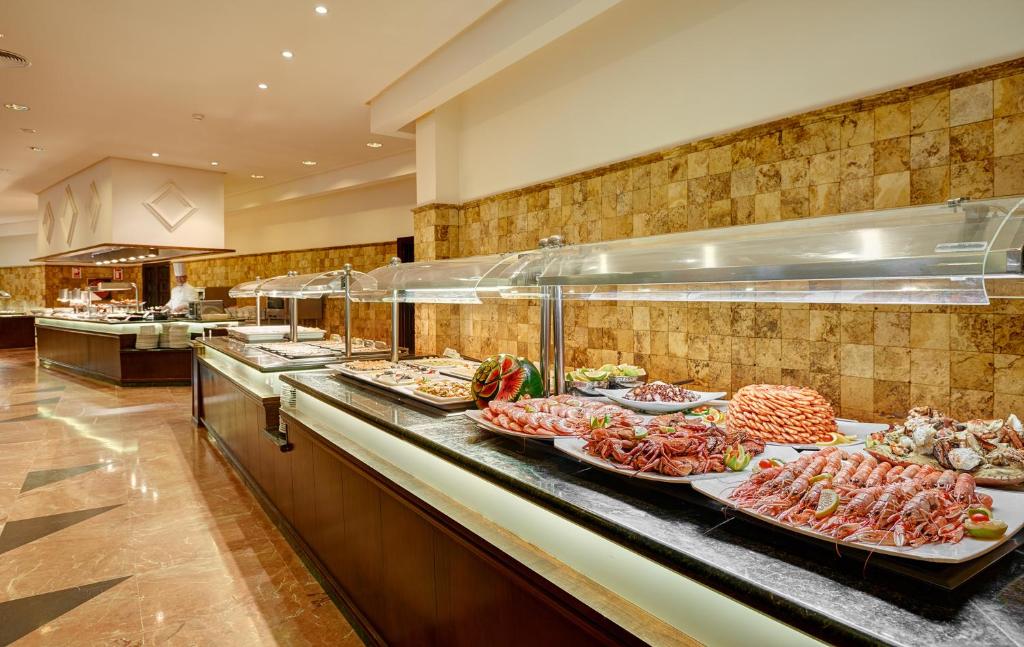 a buffet line with many different types of food at Hipotels Natura Palace Adults Only in Playa Blanca