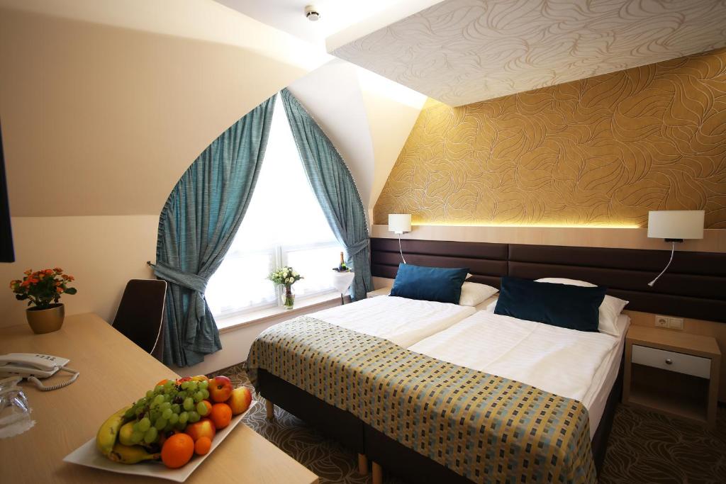 Postel nebo postele na pokoji v ubytování Hotel Kiss