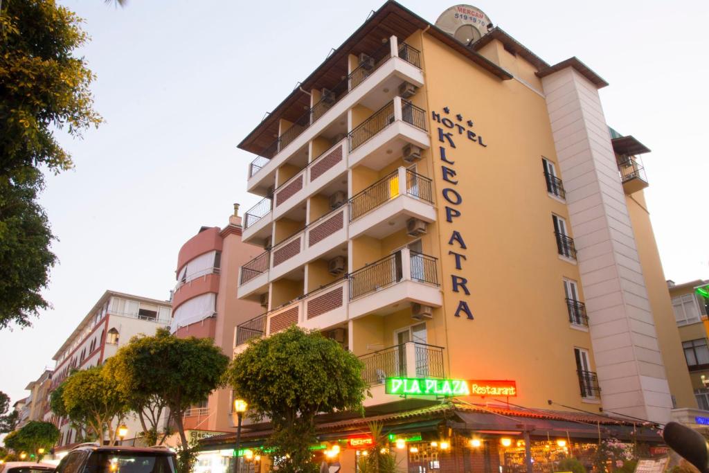 a building with a sign on the side of it at Hotel Kleopatra in Alanya
