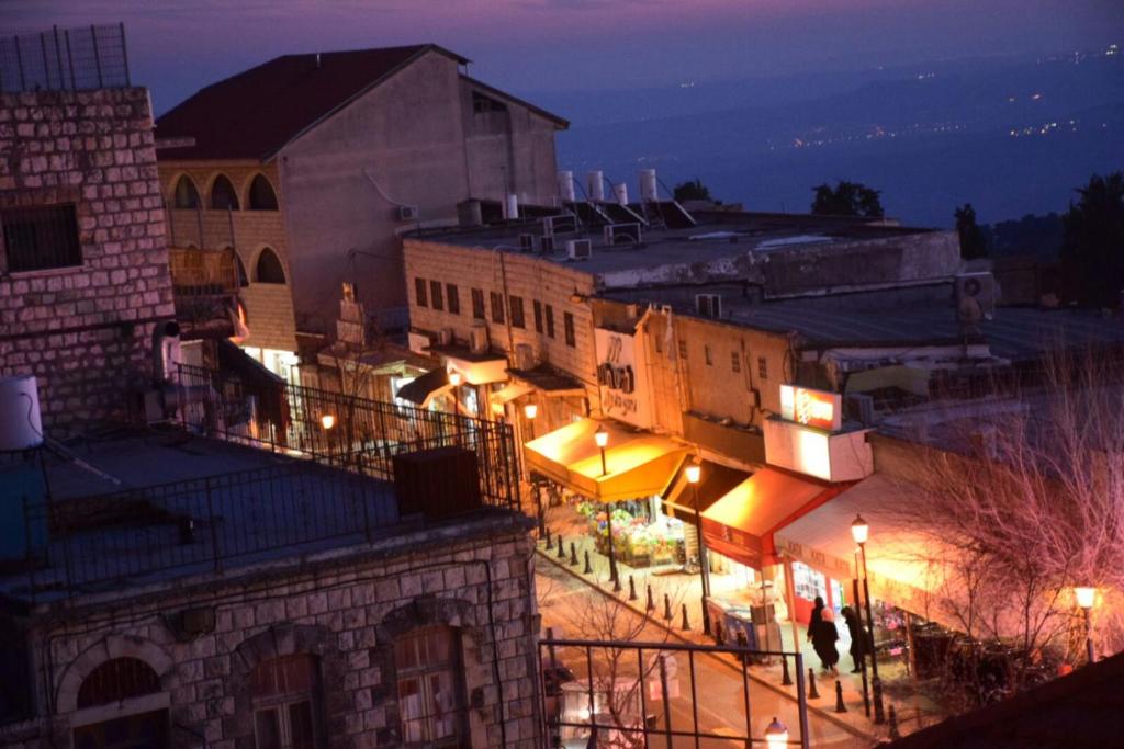 a view of a city at night with lights at Mol Hahr in Safed