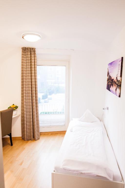 Postel nebo postele na pokoji v ubytování Hotel Martinihof