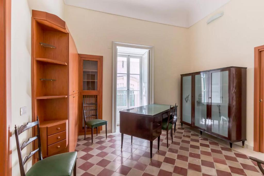 an office with a desk and a cabinet and a checkered floor at Casa Santa Barbara in Modica