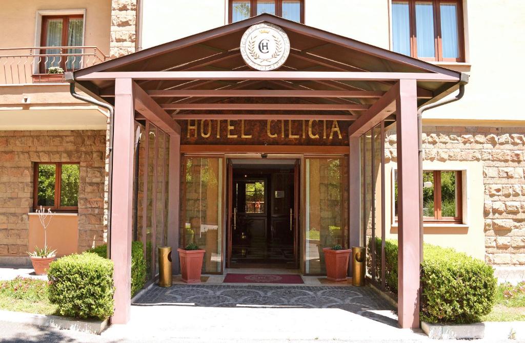 a hotel entrance with a sign on top of it at Hotel Cilicia in Rome