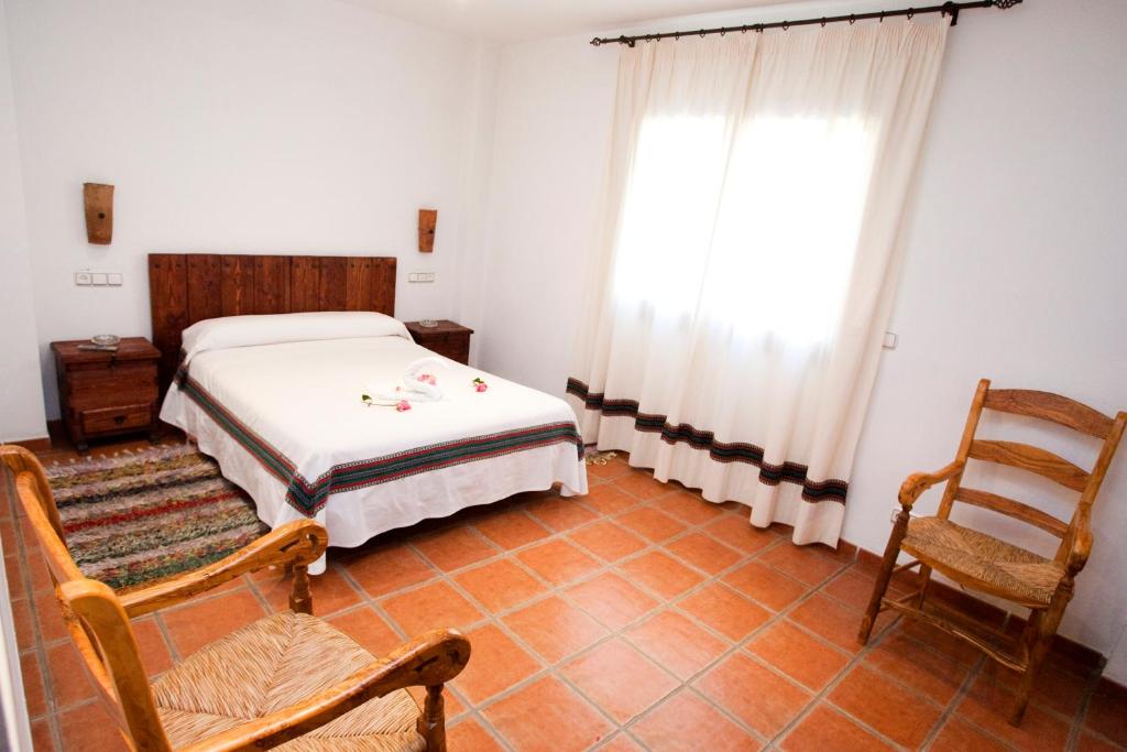Cama o camas de una habitación en Hostal Mulhacen