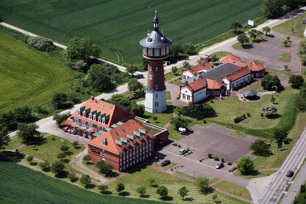 an aerial view of a building with a clock tower at Turmhotel Schwedt in Schwedt