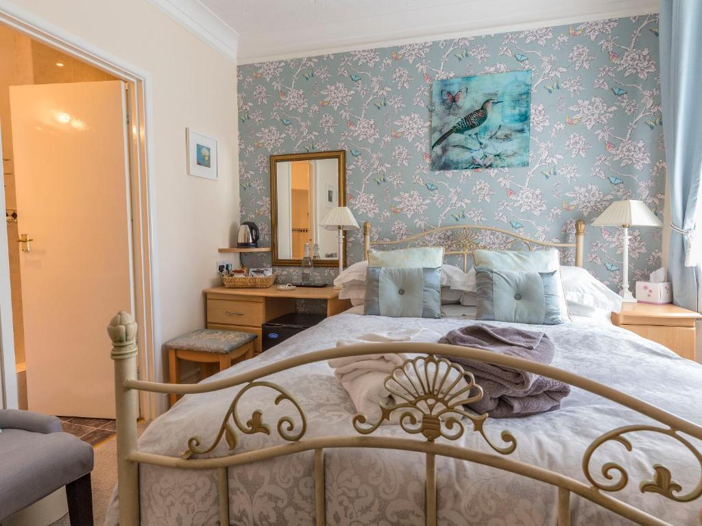 Postel nebo postele na pokoji v ubytování Dolphin Guest House