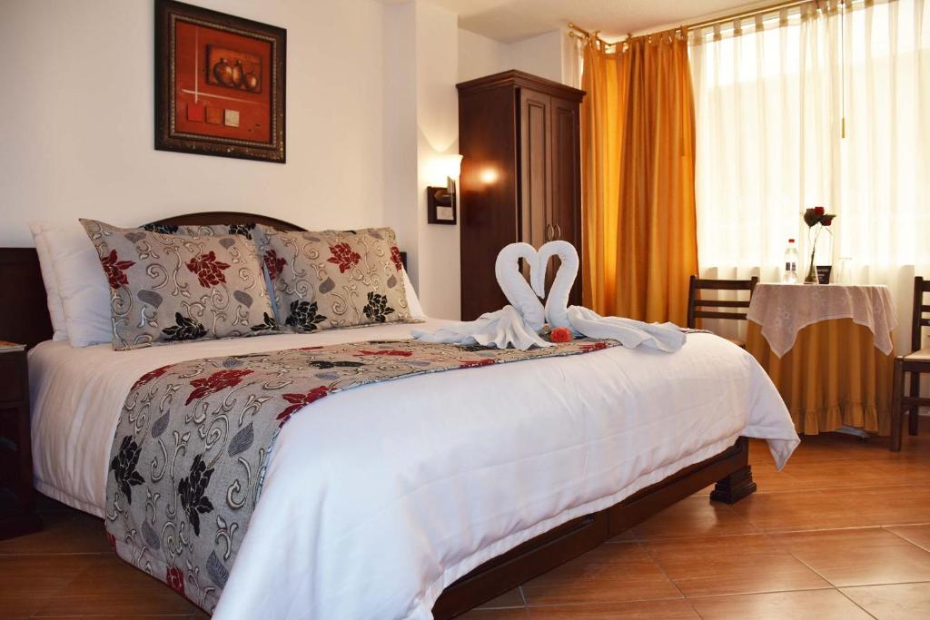 Postel nebo postele na pokoji v ubytování Hotel Plaza Victoria