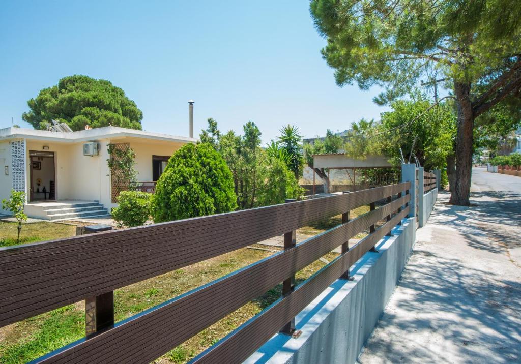 a wooden fence in front of a house at Country House in Pastida