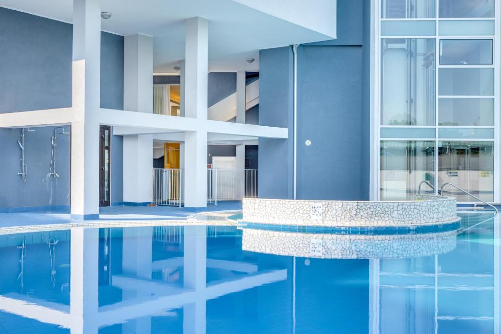 a swimming pool in the middle of a building at Hotel Ambassador in Caorle