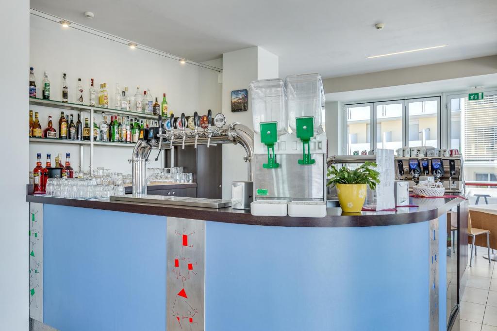 a bar in a restaurant with a counter top at Hotel Ambassador in Caorle