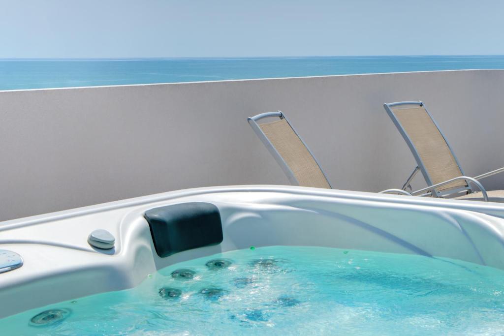 a bath tub with blue water in it at Hotel Ambassador in Caorle