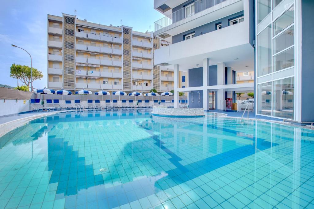an image of a swimming pool in a building at Hotel Ambassador in Caorle