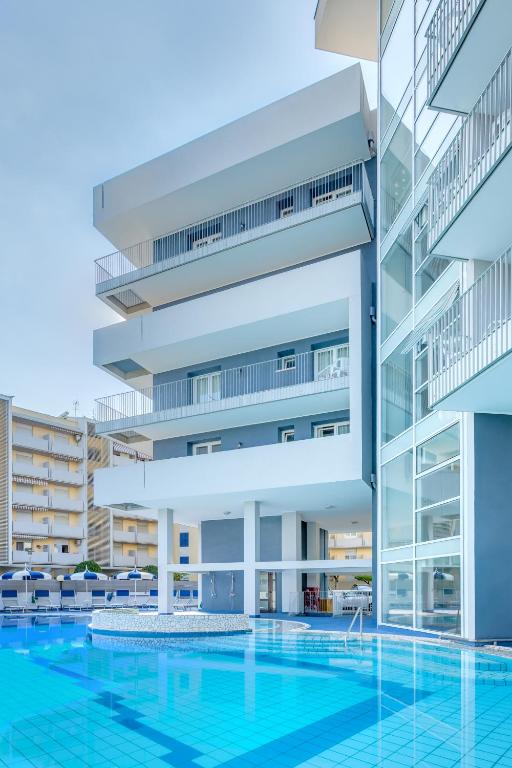an image of a building with a swimming pool at Hotel Ambassador in Caorle