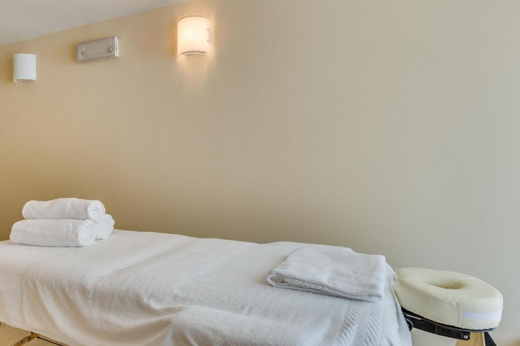 a hospital room with a bed with towels on it at Hotel Ambassador in Caorle