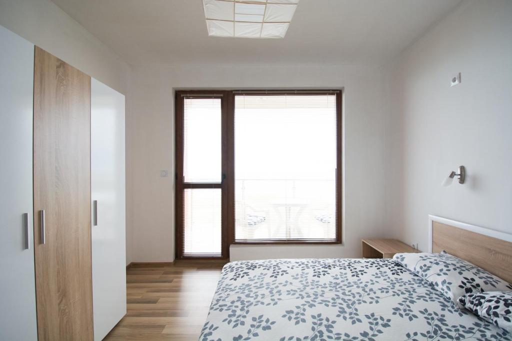 Postel nebo postele na pokoji v ubytování Sunrise Apartments