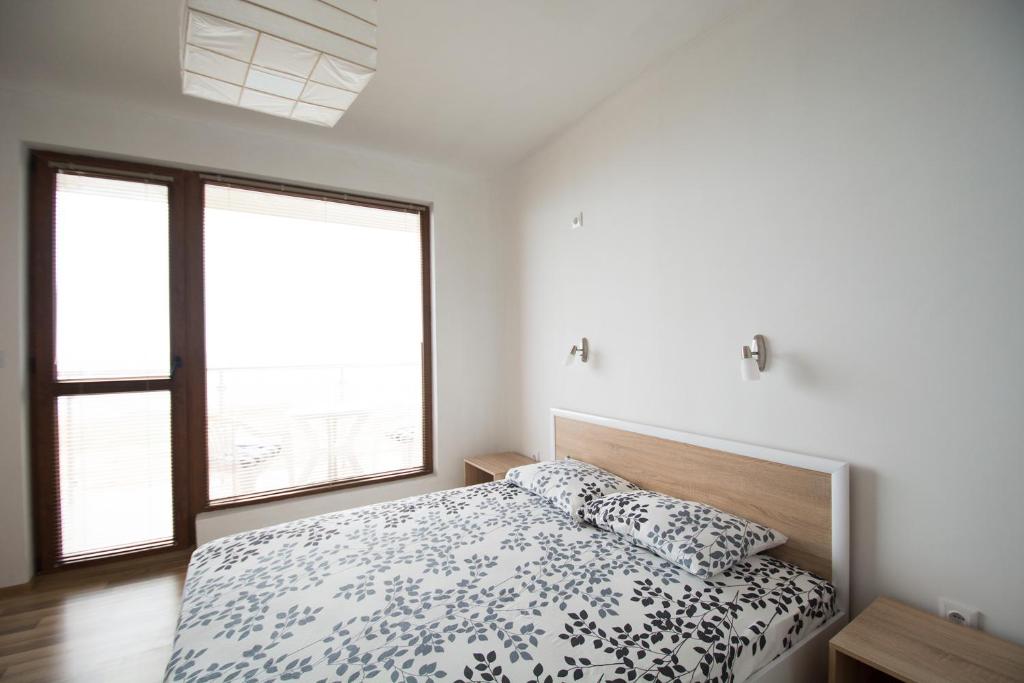 Postel nebo postele na pokoji v ubytování Sunrise Apartments