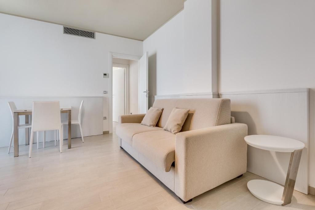a living room with a couch and a table at Hotel Ambassador in Caorle