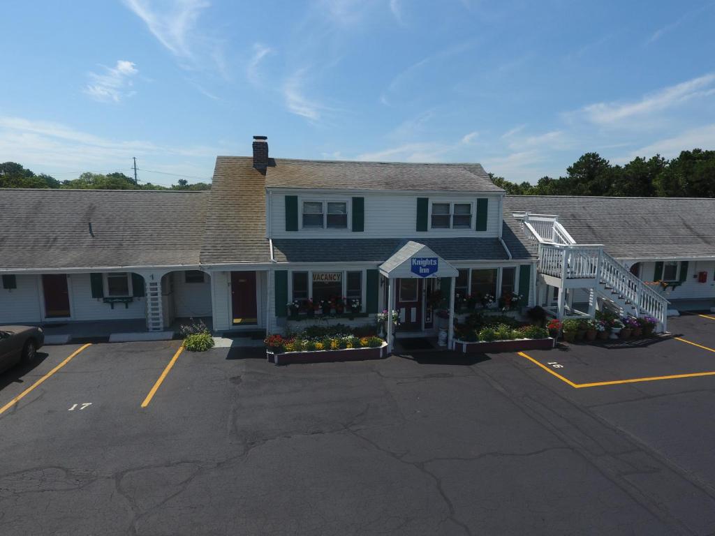 a parking lot in front of a blue building at Knights Inn Centerville Cape Cod Area in Centerville