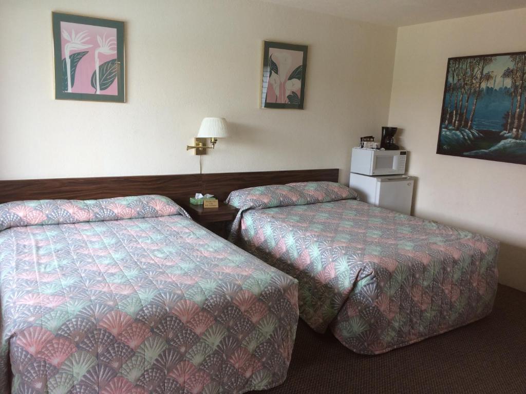 Postel nebo postele na pokoji v ubytování Crystal Sands Motel