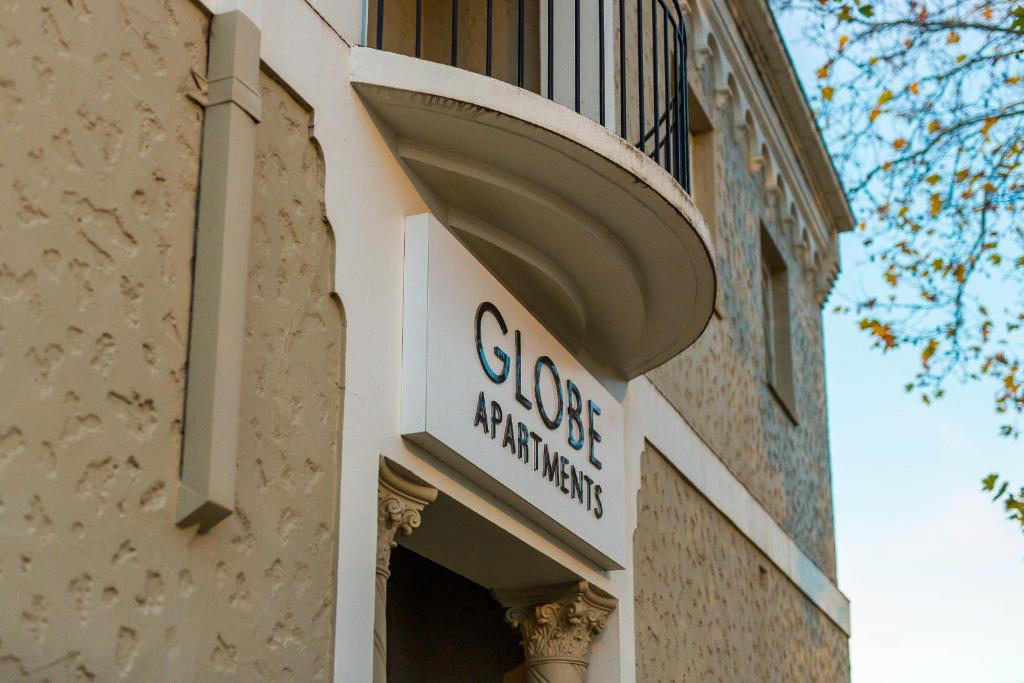 a store sign on the side of a building at Globe Apartments in Wagga Wagga