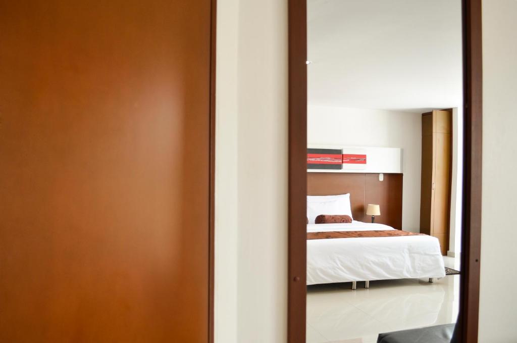 Una cama o camas en una habitación de Hotel Tarigua Ocaña