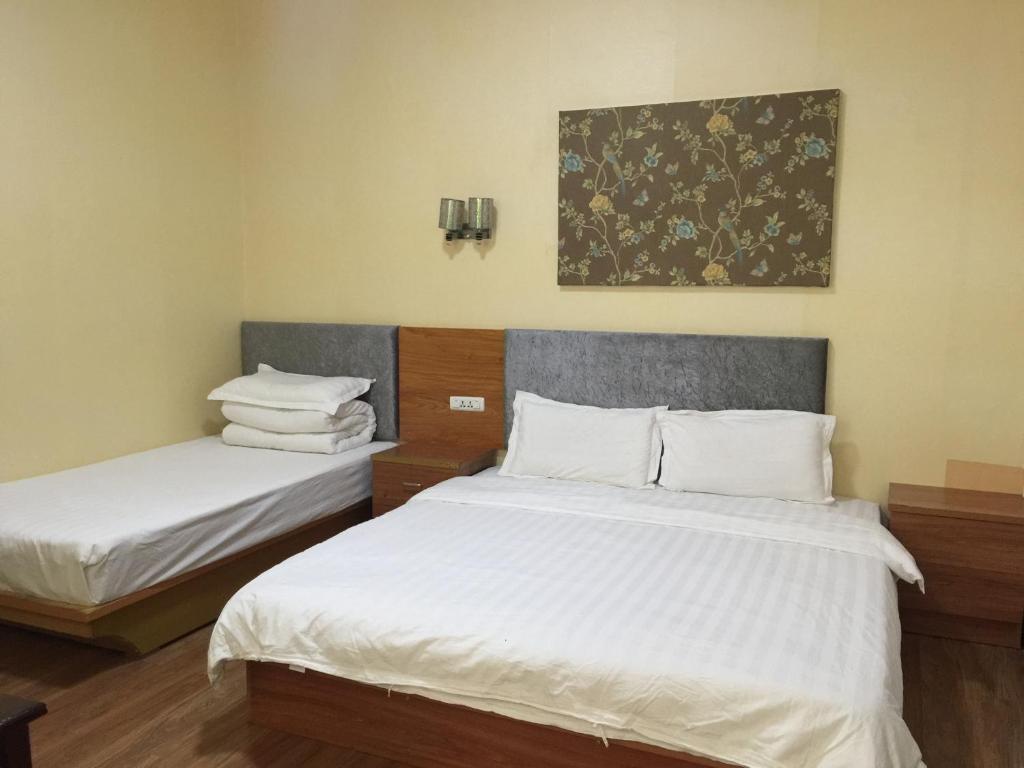 Postel nebo postele na pokoji v ubytování Huashan Gehui Hotel