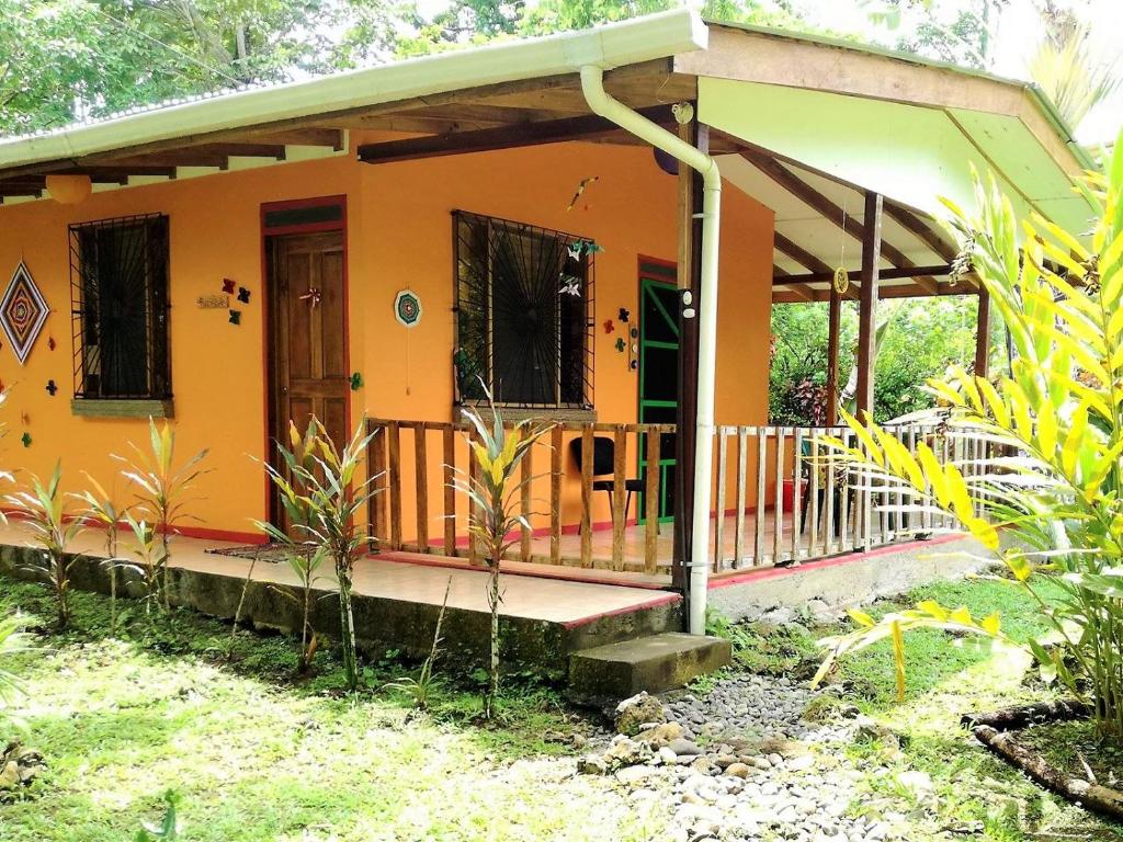 
a house with a fence and a patio area at Cabinas Caribe Luna in Cahuita

