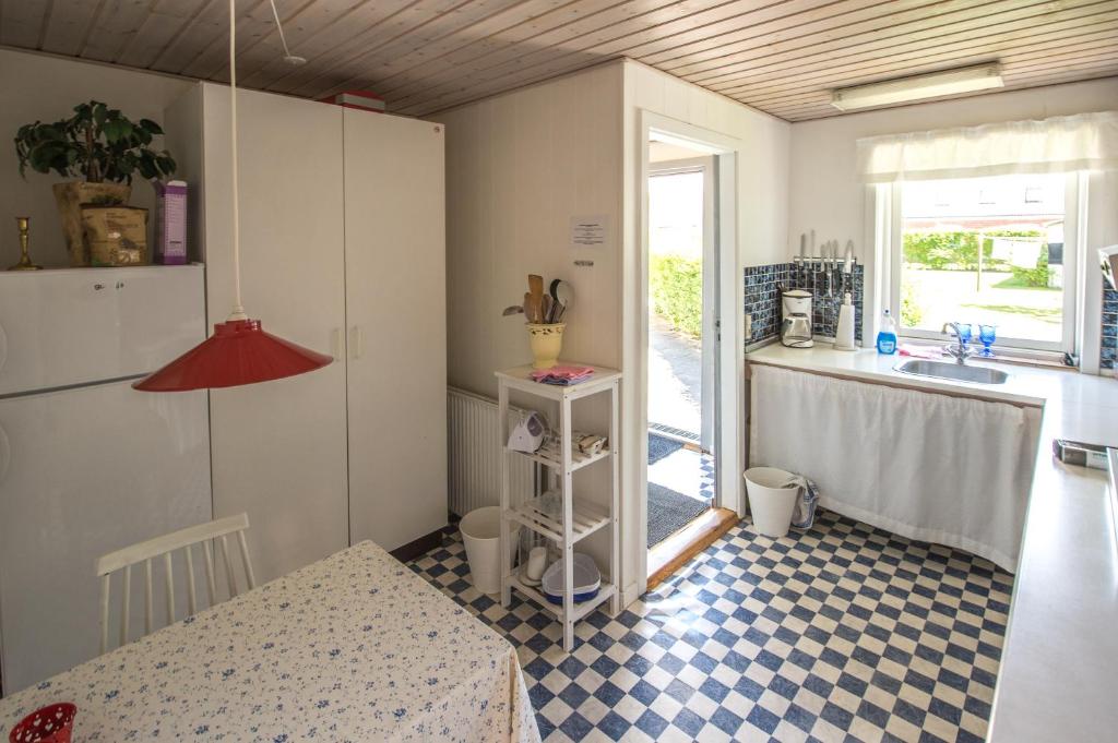 a kitchen with a checkered floor and a sink at Annekset Vesterø Havn in Læsø