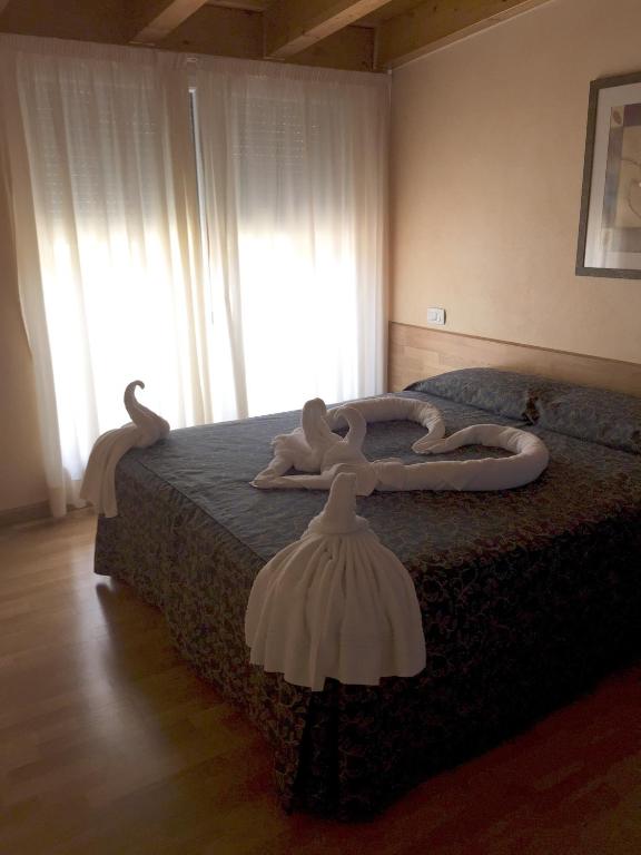 Postel nebo postele na pokoji v ubytování Hotel Concordia