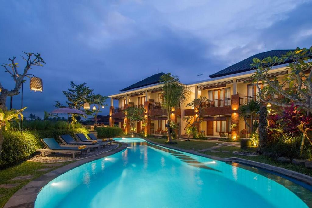 an exterior view of a villa with a swimming pool at Pondok Massas Ubud in Ubud