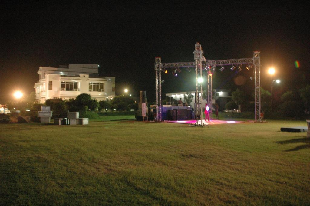 a large field at night with a building and lights at Hotel Vikramaditya in Gangānagar