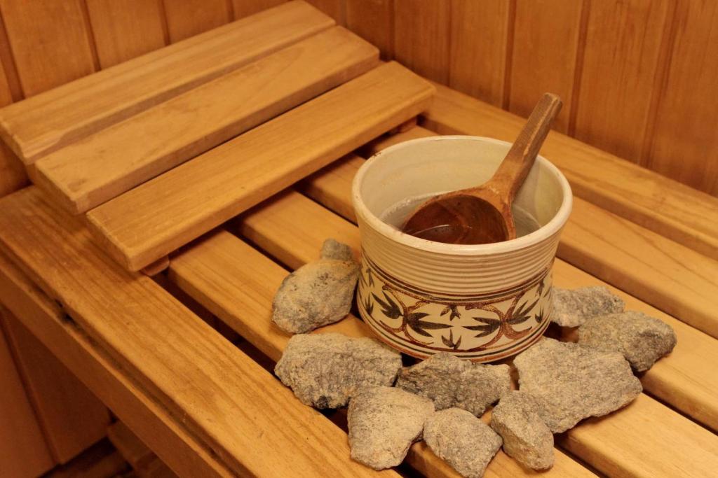 a cup with a spoon on a tray with rocks at Hotel Adret in Les Deux Alpes