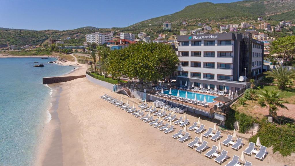 an aerial view of a beach with chairs and a hotel at Floria Beach Hotel in Alanya