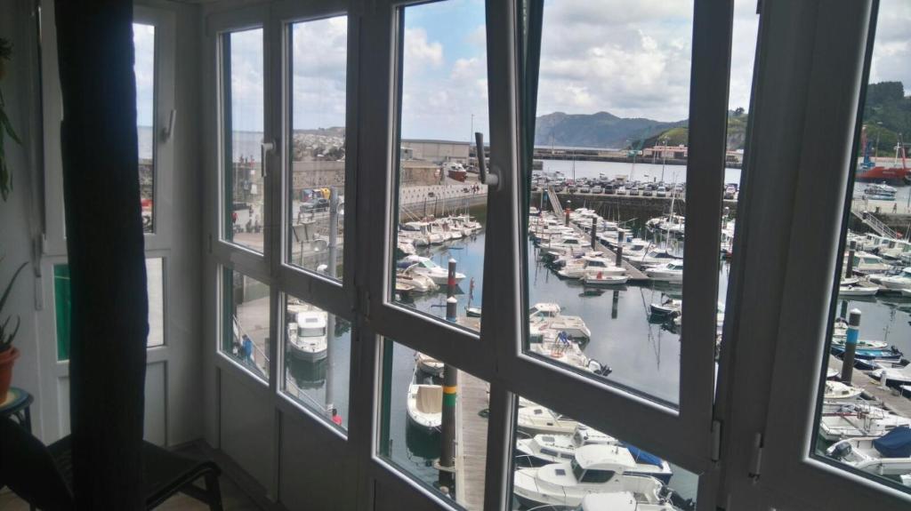 a view from a window of a marina with boats at Andra Mari Portua in Bermeo