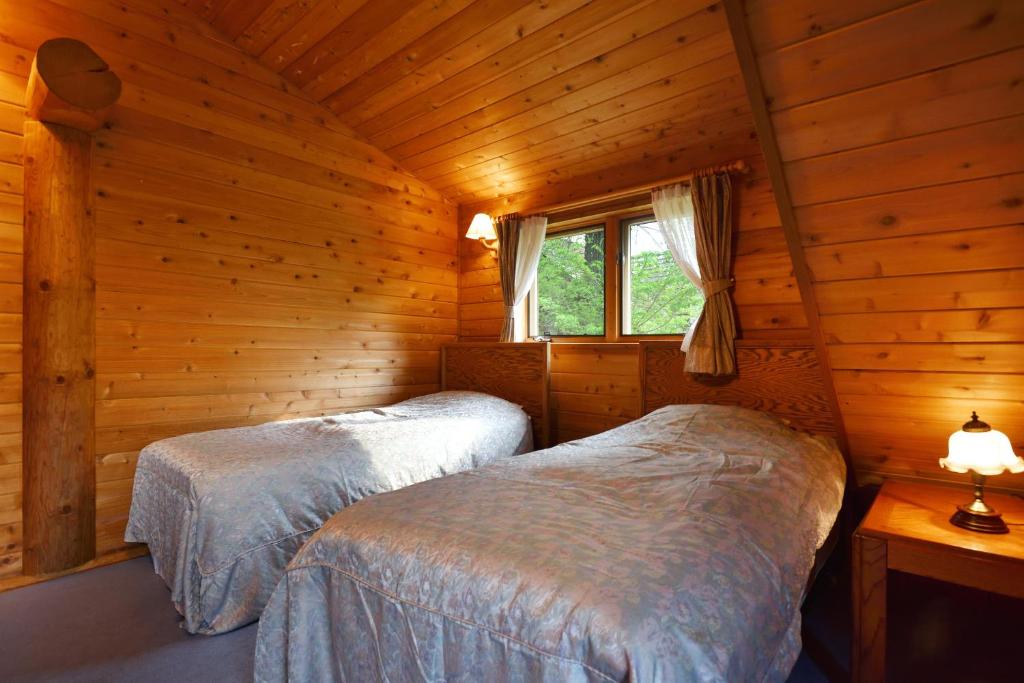 Postel nebo postele na pokoji v ubytování Rental Log Urube Village