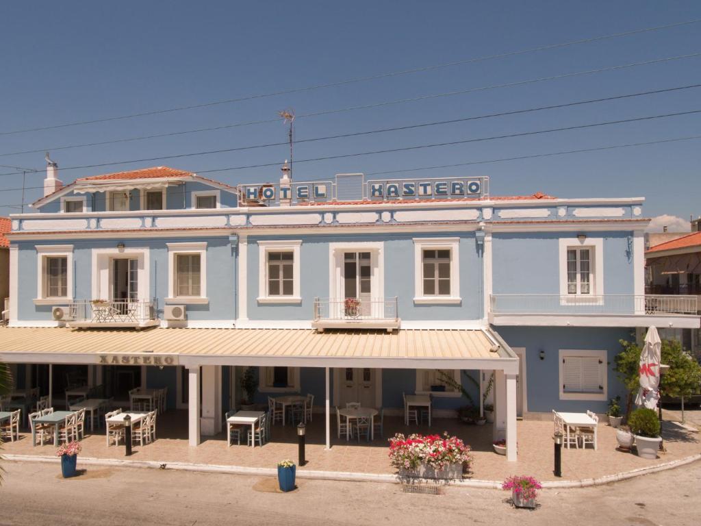 a blue building with a sign that reads hotel inspector at Xastero in Keramotí