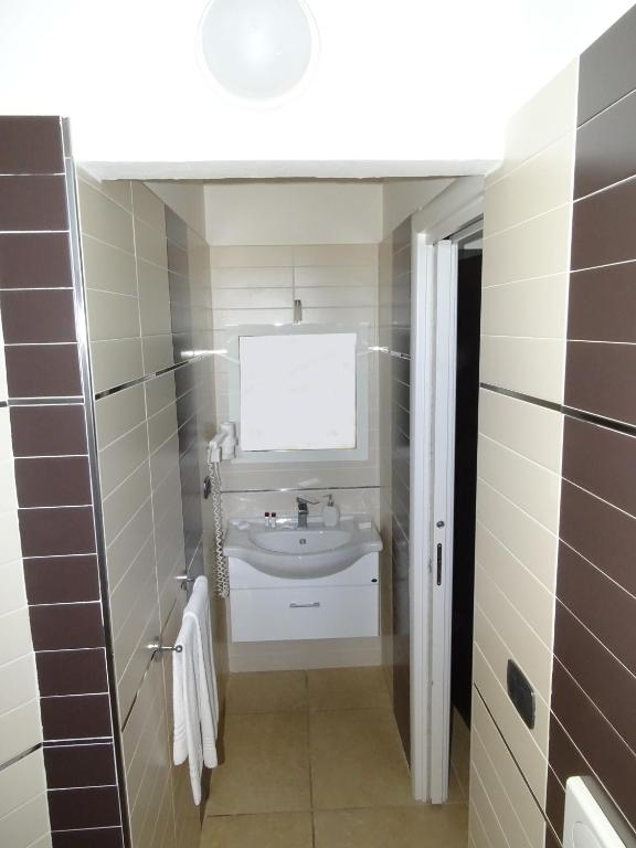 łazienka z umywalką i lustrem w obiekcie B&B Soleluna w mieście Veglie