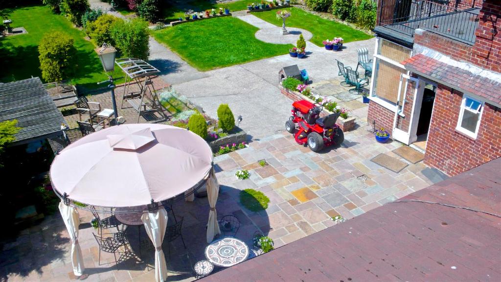 an overhead view of a patio with a table and an umbrella at Acorn Guest House in Hull in Hull