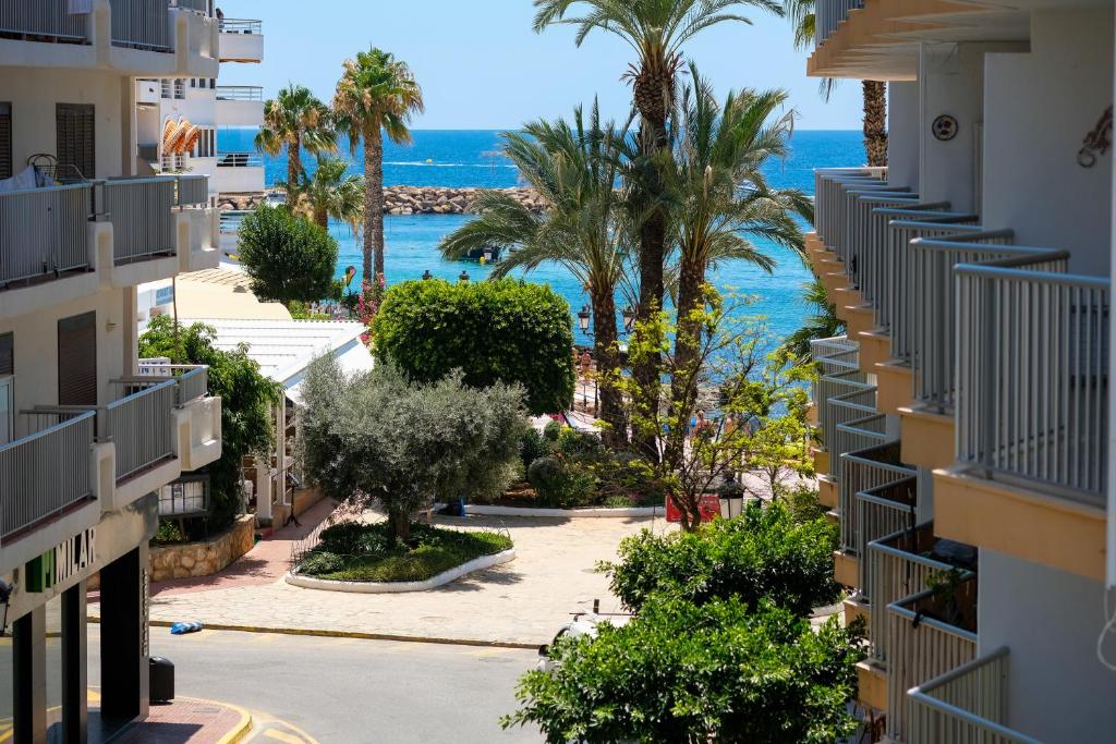 a view of the ocean from a building at Sal Mar Suites in Santa Eularia des Riu