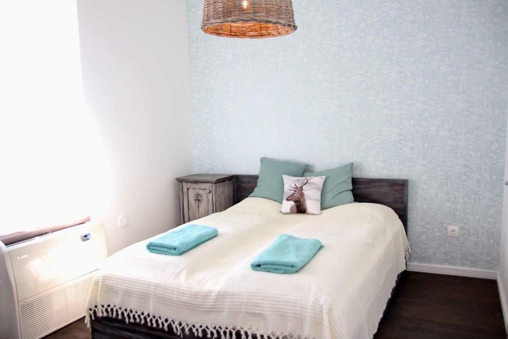 a bedroom with a bed with two towels on it at Vánkos in Badacsonyörs