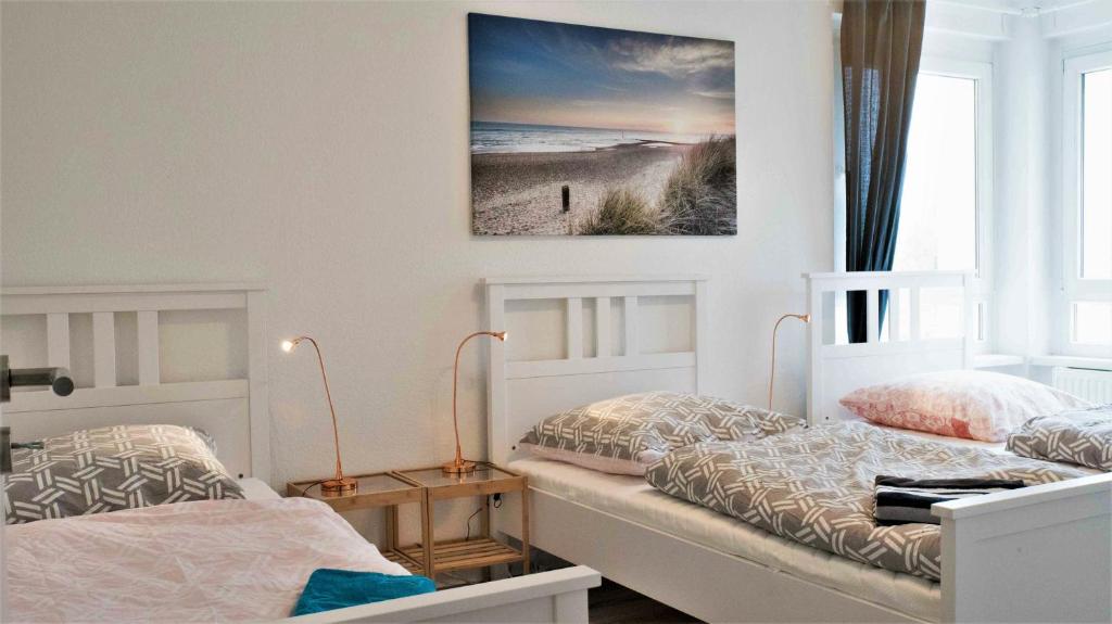 sypialnia z 2 łóżkami i zdjęciem na ścianie w obiekcie Stay and Work Düsseldorf w mieście Düsseldorf