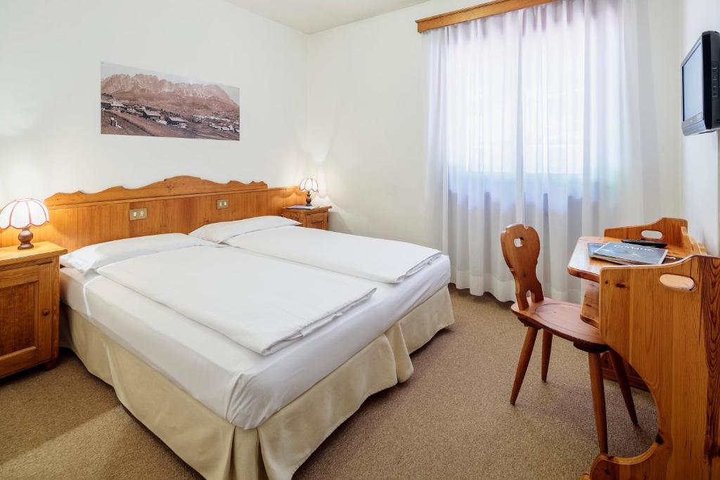 Postel nebo postele na pokoji v ubytování Hotel Al Larin