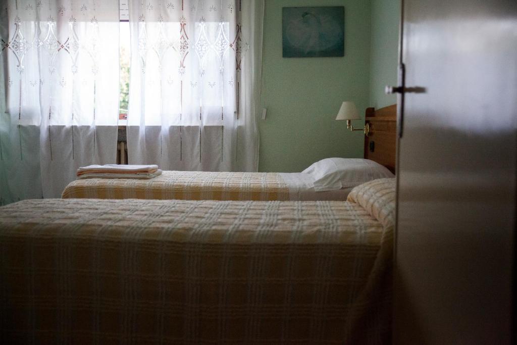 Postel nebo postele na pokoji v ubytování Hotel Trieste