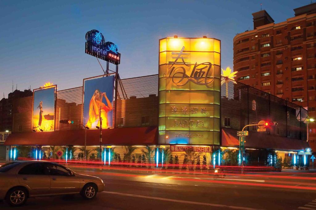 a car parked in front of a building at night at Spring Breeze Boutique Motel in Kaohsiung