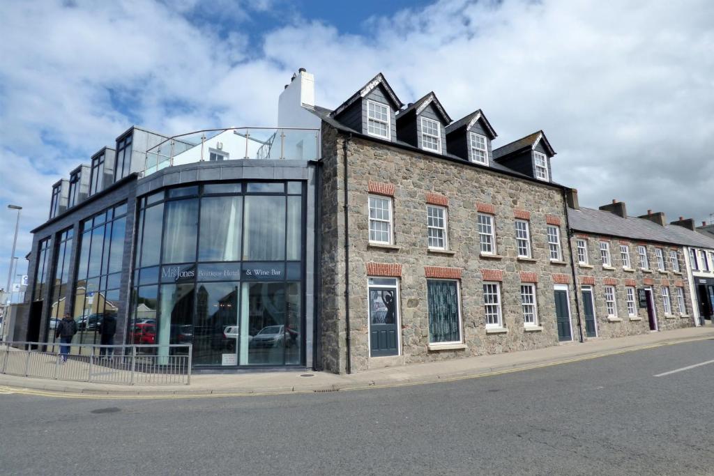 a large brick building on the side of a street at Me & Mrs Jones in Portstewart